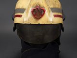 an old fireman ' s helmet on display on a black surface