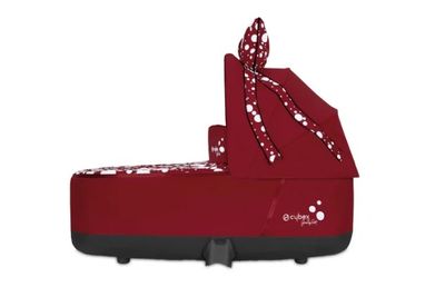 the baby seat is red and has polka dots on it