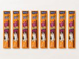 four large dog chew sticks are lined up on a white surface