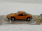 an orange toy car sitting on top of a plastic tray