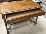 a wooden table with a drawer on top of it