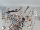 many different types of necklaces and bracelets on the table