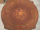 an image of a wooden table with a flower design on it