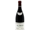 a bottle of red wine sitting on top of a white table
