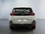 the rear end of a white car in a white room