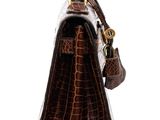 the brown crocodile skin handbag is on display against a white background