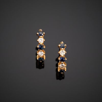 a pair of sapphire and diamond earrings