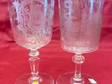 two wine glasses that are sitting on a table
