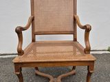 an old wooden chair with cane back and cane seat