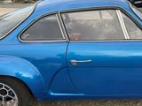 a blue car that is parked in a parking lot