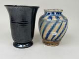 two vases sitting next to each other on a table