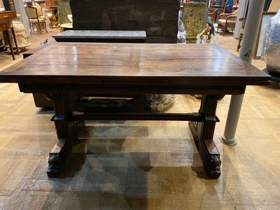a large wooden table that is sitting on a hard wood floor