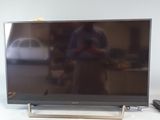 a flat screen tv sitting on top of a table