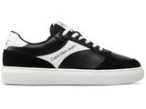 a black and white sneakers with a white sole
