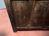 a small wooden cabinet with a door on top of it