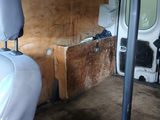 a white van with a wooden seat and a seat back