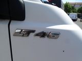 a close up of a white truck parked in a parking lot