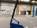an image of a baseball bat laying on a bench in a warehouse