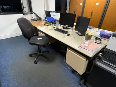 a desk with two computers and a printer on it
