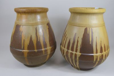 two brown vases sitting next to each other on a table