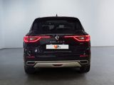 the rear end of a black suv parked in a white room