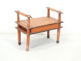 a small wooden bench with a wooden seat on top of it
