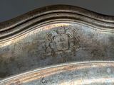 a silver plate with a coat of arms on it