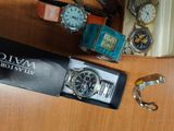 a box of watches and a pair of scissors on a table
