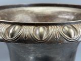 a silver vase that is sitting on a table