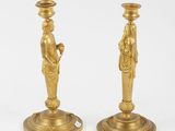 pair of antique brass candlesticks with figurines on bases