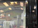 a reflection of a person in the window of a vending machine