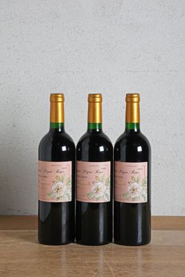 three bottles of wine sitting on top of a wooden table