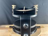 a close up of a stove top with a bunch of pans on it