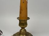 brass plated table lamp with a brown glass shade and a red cord