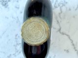a bottle of wine sitting on a marble table