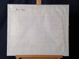 a picture of an easel with a white basket on top of it