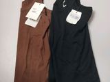 deux robes pour femmes, encore étiquetées, posées sur une table