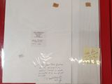 a piece of paper with writing on it sitting on a red surface
