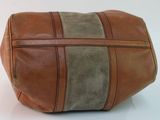brown and tan leather toilet bag on a white surface