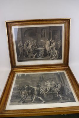 deux tableaux encadrés représentant un homme et une femme dans une cuisine