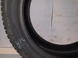 a close up of a tire on a white surface with a white wall in the background