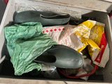 a white box filled with shoes and bags of food