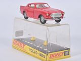 une petite voiture rouge posée sur une boîte transparente