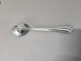 a silver spoon with a spoon handle on a table
