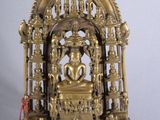 brass figurine of an elephant in a cage on a white background