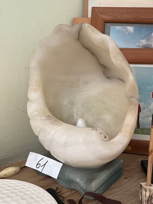 a picture of a clam shell on a table next to other items