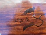 a bird that is sitting on top of a wooden table