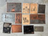 many different types of old metal plates on the floor