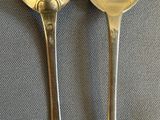 two spoons sitting next to each other on a table