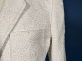a close up of a white jacket on a mannequin mannequin
